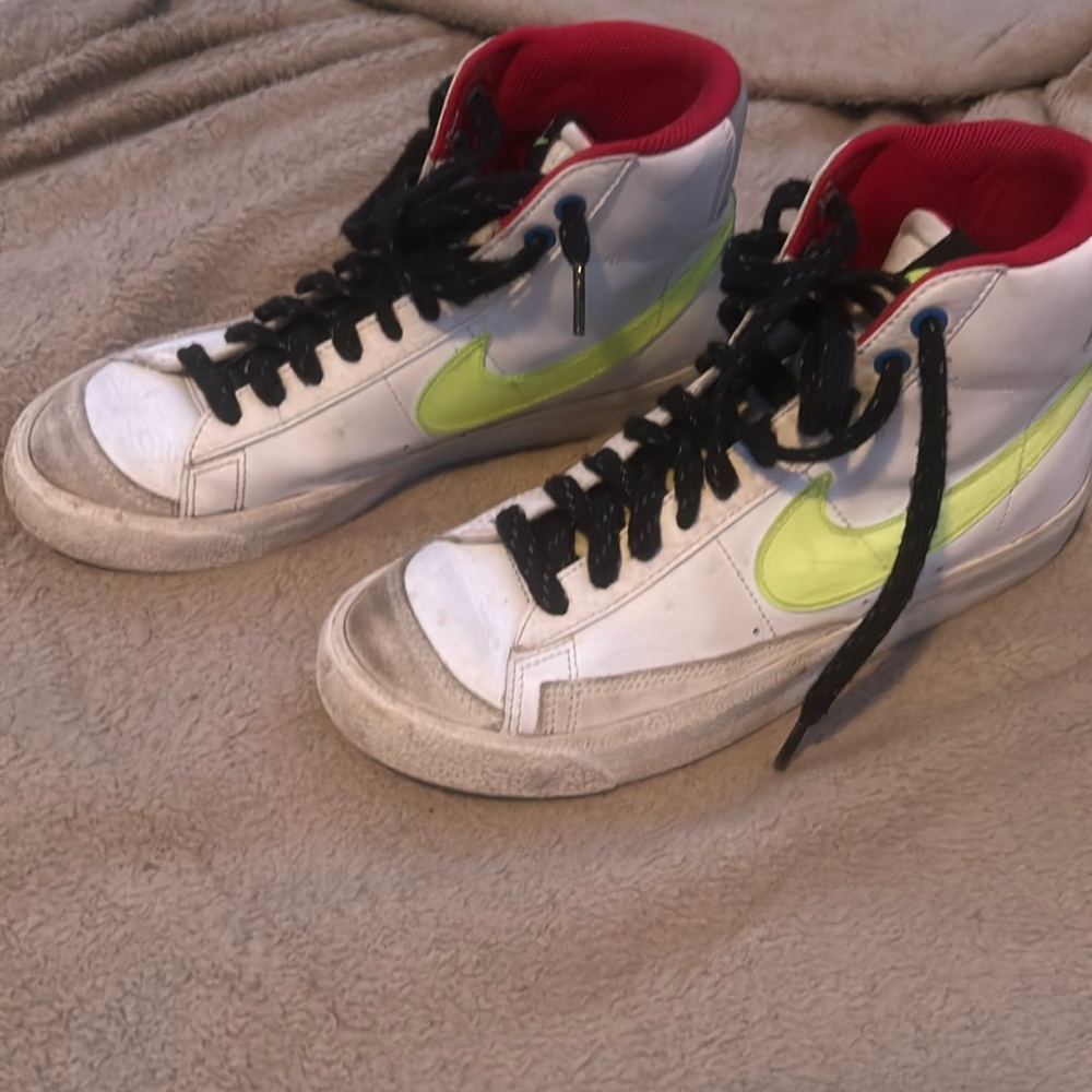 These shoes are still in good condition and they have a neon Nike stripe.